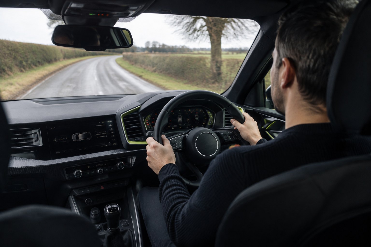 A buyer carrying out a careful insured test drive in a modern right-hand-drive vehicle